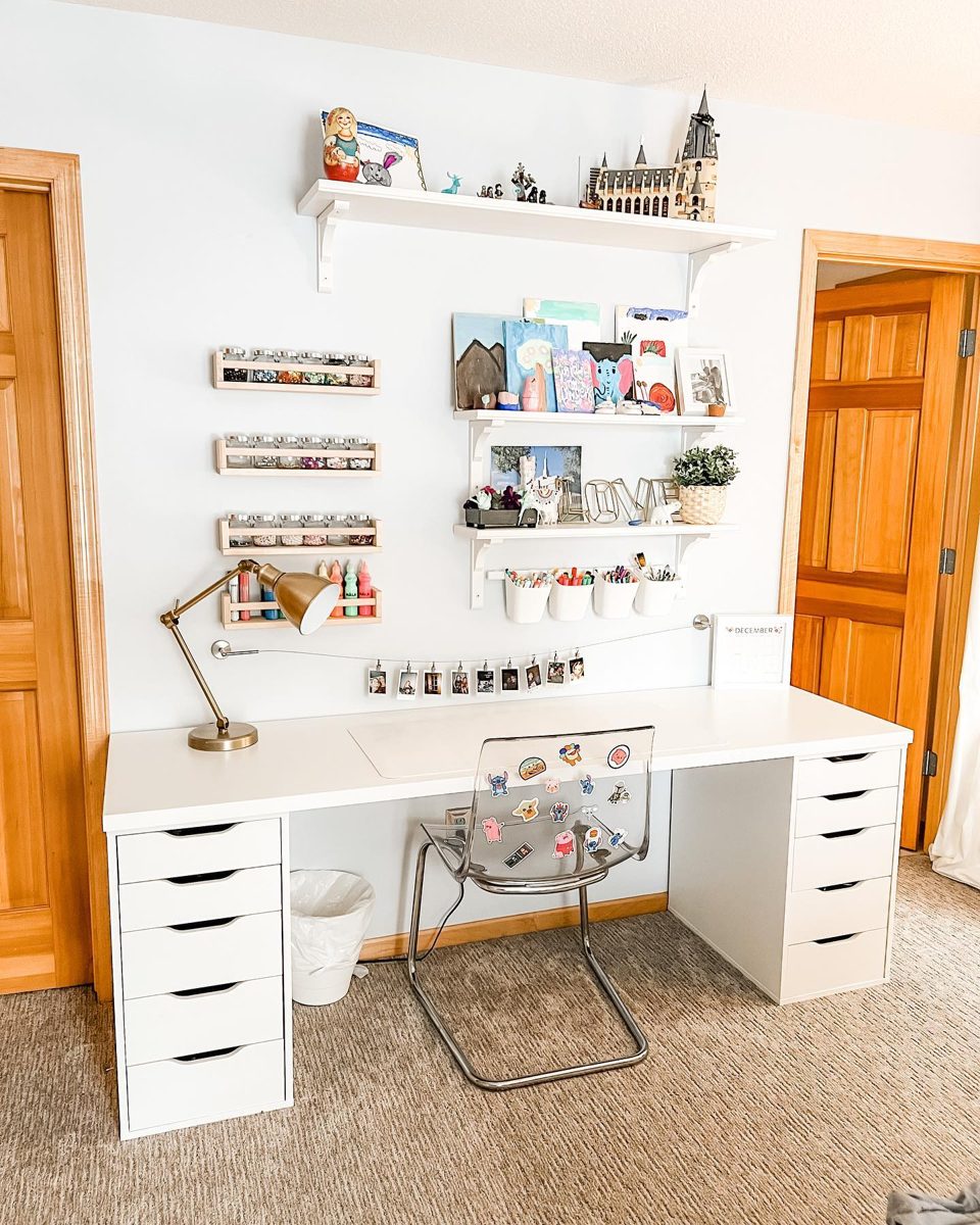 Kids' craft desk with wall-mounted racks of art supplies and labeled cups
