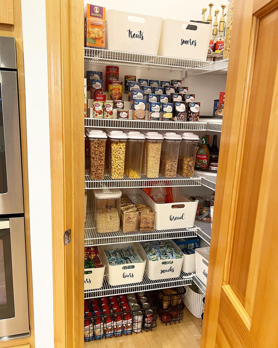 Pantry with labeled white bins for treats, bread, bars, and snacks